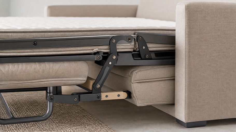 Close-up of a high-quality sleeper sofa opening mechanism, showing premium metal and wood components with beige fabric